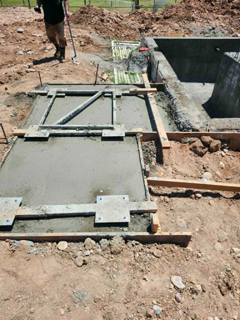 Foundation pour with metal anchor plates